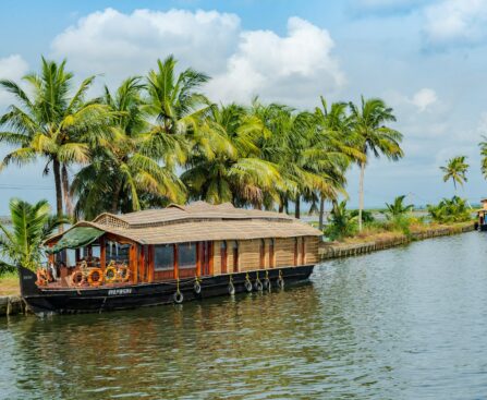 Traditional houseboat cruising through the backwaters of Alappuzha, Kerala.