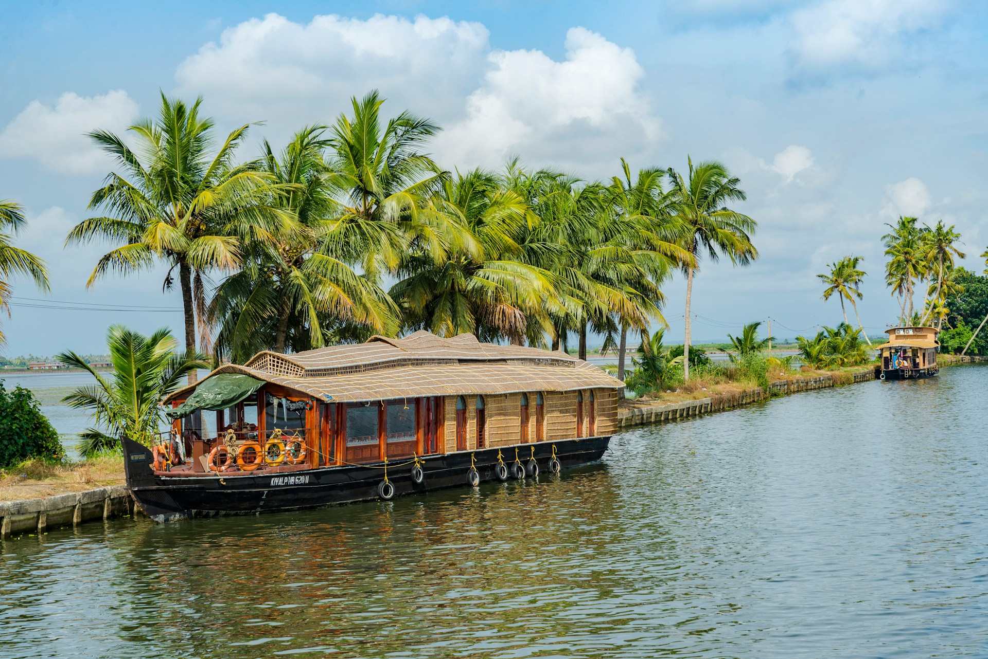 Traditional houseboat cruising through the backwaters of Alappuzha, Kerala.