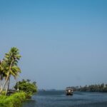 Scenic waterways of Alappuzha, Kerala, lined with lush greenery and traditional boats.