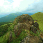 Scenic view of Ranipuram Hills with lush greenery and misty peaks in Kasargod, Kerala.