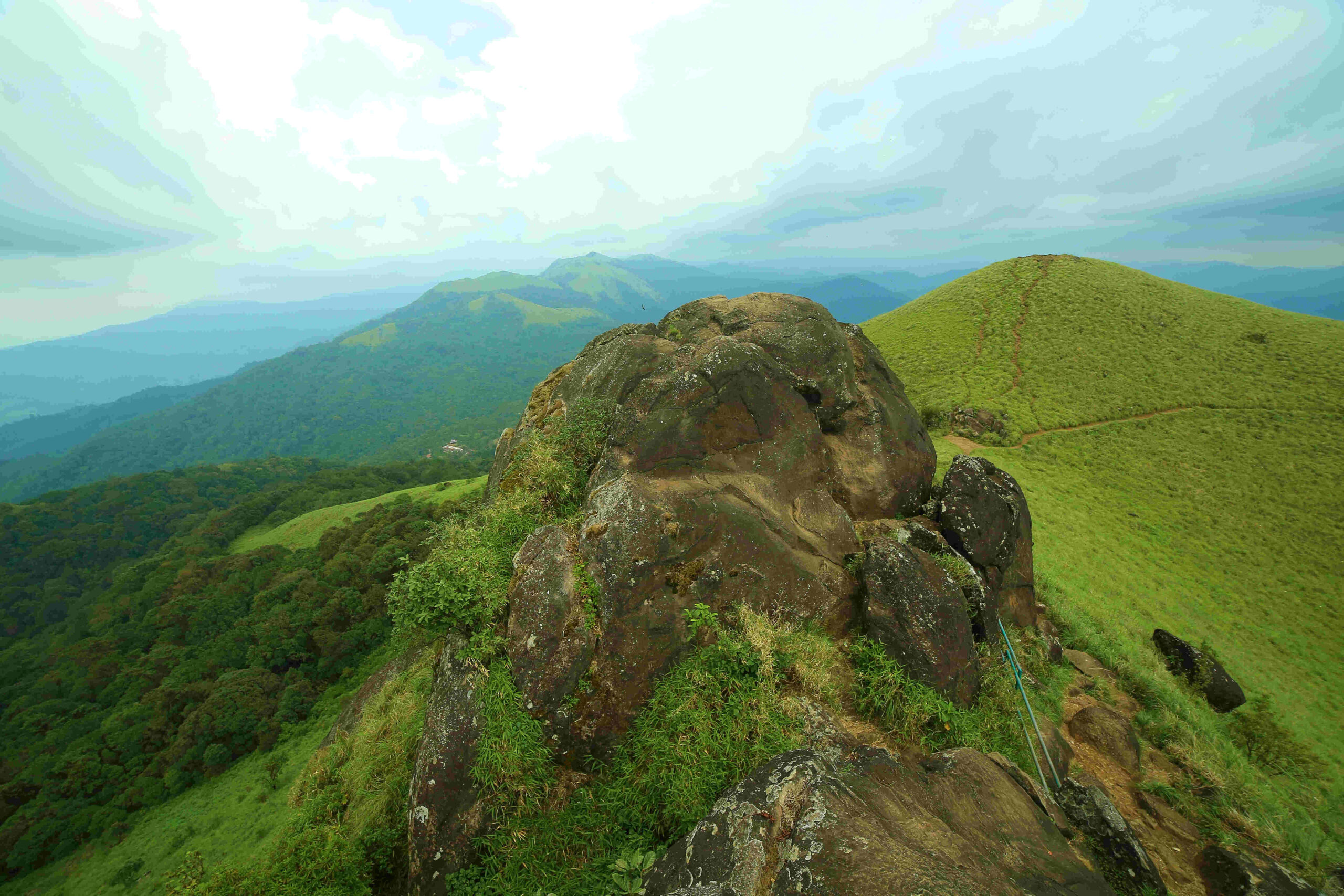 Scenic view of Ranipuram Hills with lush greenery and misty peaks in Kasargod, Kerala.